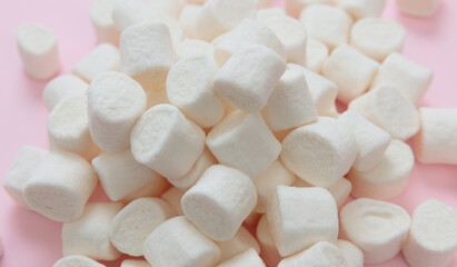 Wall Mural - Marshmallows on pink background. White fluffy mini dessert, sweet kids birthday party snack