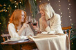 lesbian couple having dinner in a restaurant. Girls drink wine and talk