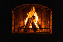 Glowing Fire In Home Stone Fireplace