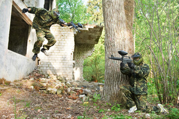 Wall Mural - paintball action game. player jumping and attacking