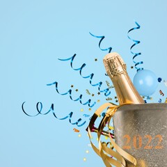 Wall Mural - A bottle of champagne on a background decorated with confetti and numbers 2022 .New Years celebration