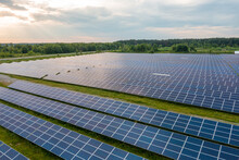 Huge Solar Power Plant To Use Solar Energy In A Picturesque Green Field In Ukraine. Aerial Panoramic Drone Shot