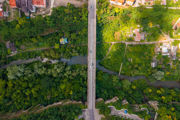 Wall Mural - Aerial view of th ebeautiful bridge going over the green valley in Europe.