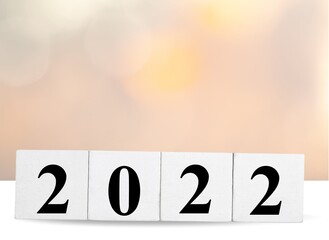 Canvas Print - Happy New Year 2022 on wood cube block and bokeh light background