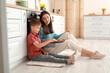 © Pixel-Shot - Little boy and his older sister with tasty baked cookies in kitchen