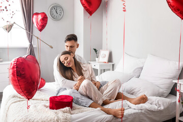 Wall Mural - Happy couple celebrating Valentine's Day in bedroom at home