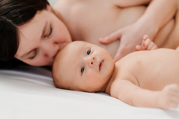 Wall Mural - breastfeeding. the baby lies next to the mother after feeding