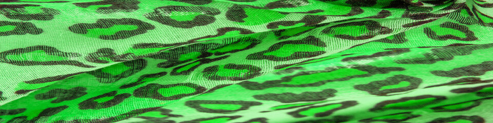 Texture, background, pattern, silk fabric green yellow with leopard print. Lightweight leopard print silk is perfect for your design, looks stylish and not vulgar!