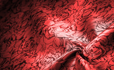 relief pattern, composite textiles, red silk fabric, with a floral pattern, unusually pleasant visual sensations: slippery, coolness, softness; beautiful appearance, unique luster