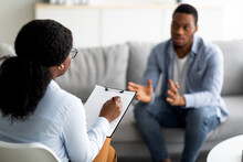 Psychological Assistance. Millennial Black Man With Depression Having Counseling Session With Therapist At Office