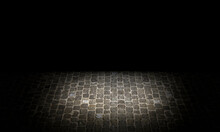 Shot Of A Cobblestone Structure On The Ground Of An Urban Street In Grey And Textured Tones With Lighting In The Centre And Copy Space At The Top. Background Concept.