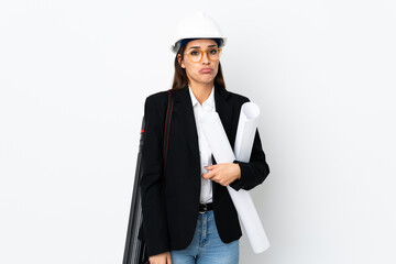 Sticker - Young architect caucasian woman with helmet and holding blueprints over isolated background sad