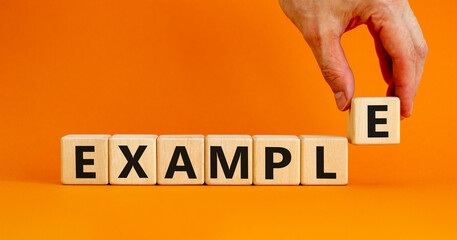example symbol. the concept word example on wooden cubes. beautiful orange table, orange background,