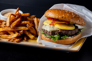 Wall Mural - details of tasty beef hamburger with gorgonzola cheese and fries