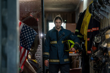 Firefighter with uniform and helmet standing at fire station,Fireman suit.