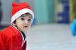© Rajesh - Indian baby girl wearing Santa Claus dress on Christmas Day crawling on the floor