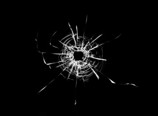 Wall Mural - Bullet hole in the glass. Isolated on a black background.