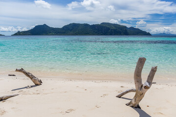 Mantabuan island with turquoise water on a sunny day, Borneo