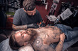 © Mr. Prof - Professional tattooer demonstrates the process of getting tattoo in tattoo studio