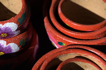 Wall Mural - Stacked bright red ceramic pots in pottery workshop in Old Town