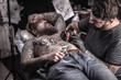 © Mr. Prof - Tattoo master makes tattoo in tattoo studio