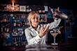 Girl barman concocts a cocktail on the taproom