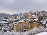 Fototapeta Do pokoju - Typical residential houses in different colors near the city center of Lucerne on a winter day with snow