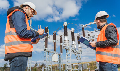 Two engineer electricians check the substation construction process