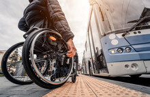 Person With A Physical Disability Waiting For City Transport With An Accessible Ramp.