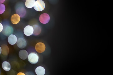 Wall Mural - multicolored defocused lights on black background
