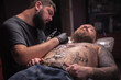© Mr. Prof - Professional tattooist draws a tattoo