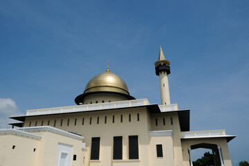 Wall Mural - Low angle picture of mosque with its new golden dome during sunny day in Mersing, Johor.