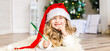 © sushytska - Little girl in Santa hat writes letter to Santa Claus