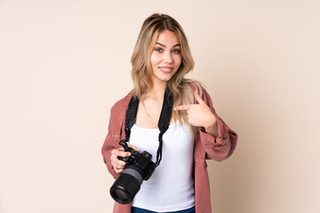 Young photographer girl over isolated background with surprise facial expression