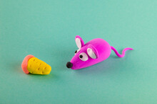 Kids Clay Creature. Small Pink Mouse Near Plasticine Cheese On Blue Background