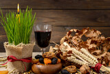 Fototapeta Na sufit - Christmas oak tree, wine, candle, bread and dried fruits