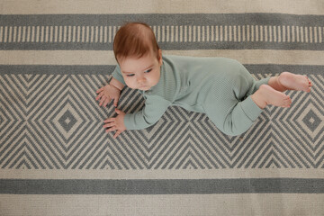 Canvas Print - Cute baby crawling on floor, top view