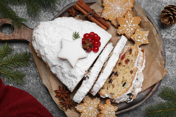 Wall Mural - Traditional Christmas Stollen with icing sugar on grey table, flat lay