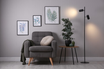 Canvas Print - Stylish room interior with comfortable armchair and green eucalyptus tree