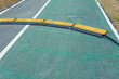 © JinnaritT - Black and yellow heavy plastic covers for people and vehicle to cross over cables laid on road. Pavement pads to protect electrical wiring on sidewalk in public park. Channel for laying the wires.