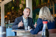 © Westend61 - Businessman gesturing talking to client in restaurant