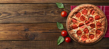 Italian Melted Cheese Pizza On A Black Table With Food Ingredients: Cherry Tomatoes, And Rosemary. Copyspace, Flat Lay, Banner.