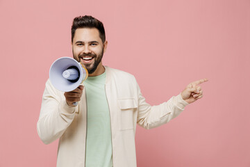 Canvas Print - Young man 20s in trendy jacket shirt hold scream in megaphone announces discounts sale Hurry up point finger aside on workspace isolated on plain pastel light pink background People lifestyle concept