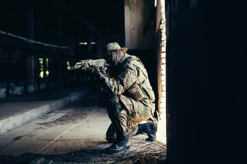 Wall Mural - Airsoft solder on battlefield. Airsoft soldier with a rifle.