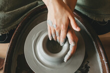 A Female Craftsman Works In A Clay Workshop On A Potter's Wheel. The Concept Of Creative People.