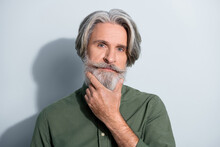 Portrait Of Attractive Well-groomed Successful Grey-haired Man Touching Beard Deciding Isolated Over Gray Pastel Color Background