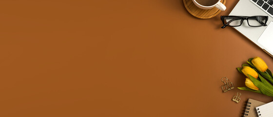 Top view office desk with blank notebook, computer, supplies and coffee cup. lat lay. Panoramic banner background with copy space.