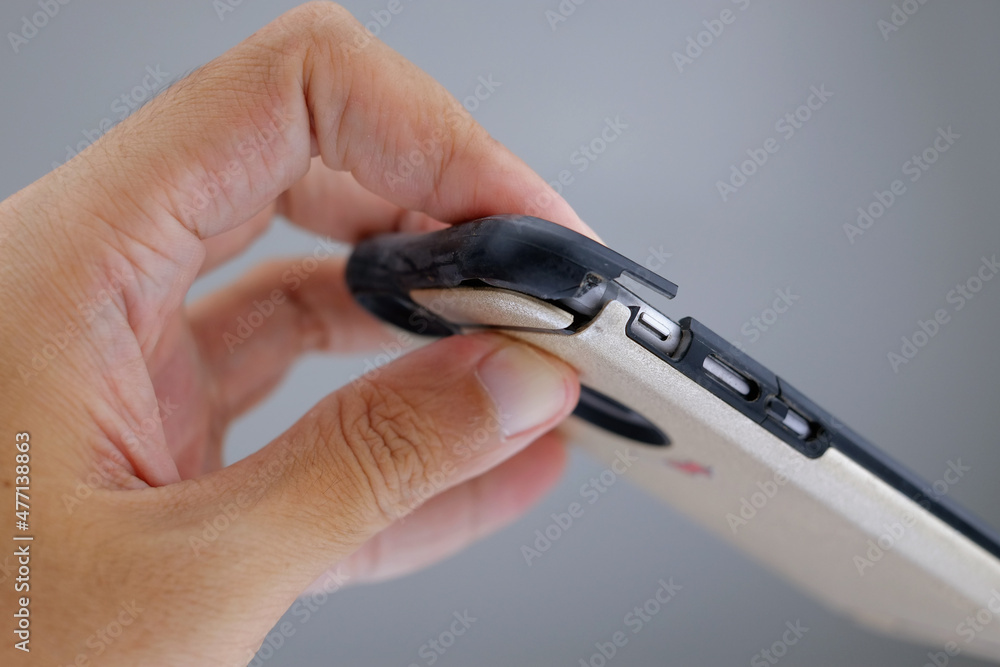 Photo of hand holding smartphone with broken phone case. Cracking smartphone case. Damaged phone case. Stock Photo | Adobe Stock Photo of hand holding smartphone with broken phone case. Cracking smartphone case. Damaged phone case. Stock Photo | Adobe Stock