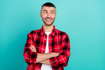 Sticker - Photo of positive happy dreamy young man look empty space hands crossed isolated on teal color background