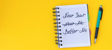 Banner With Writing In A Notebook New Year, Better Me On Yellow Background Happy New Year Quote. Top View.
